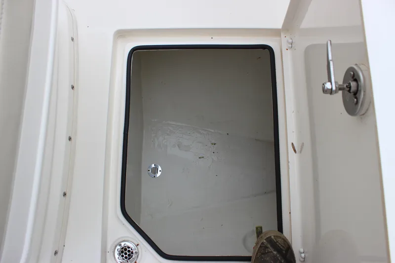 Slide: The Image of Storage compartment of 2022 Cobia 280 Center Console boat, open with visible latch. - 42