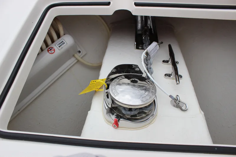 Slide: The Image of 2022 Cobia 280 Center Console anchor locker with winch and cleat. - 44