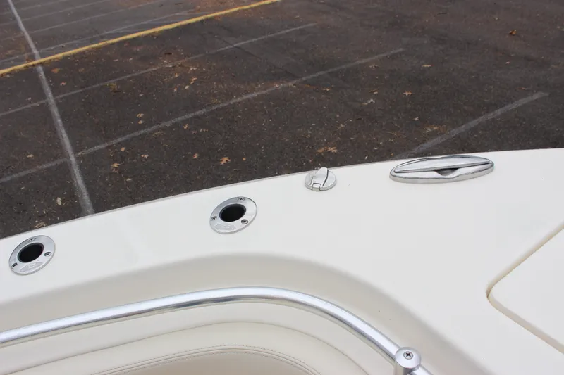 Slide: The Image of 2022 Cobia 280 Center Console boat deck with rod holders and cleat. - 46