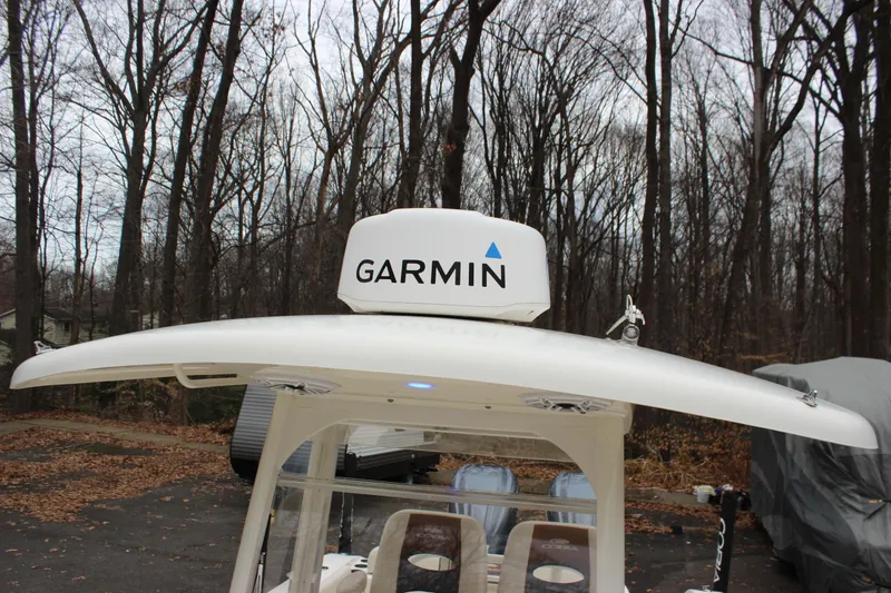 Slide: The Image of 2022 Cobia 280 Center Console with Garmin radar in wooded area. - 49