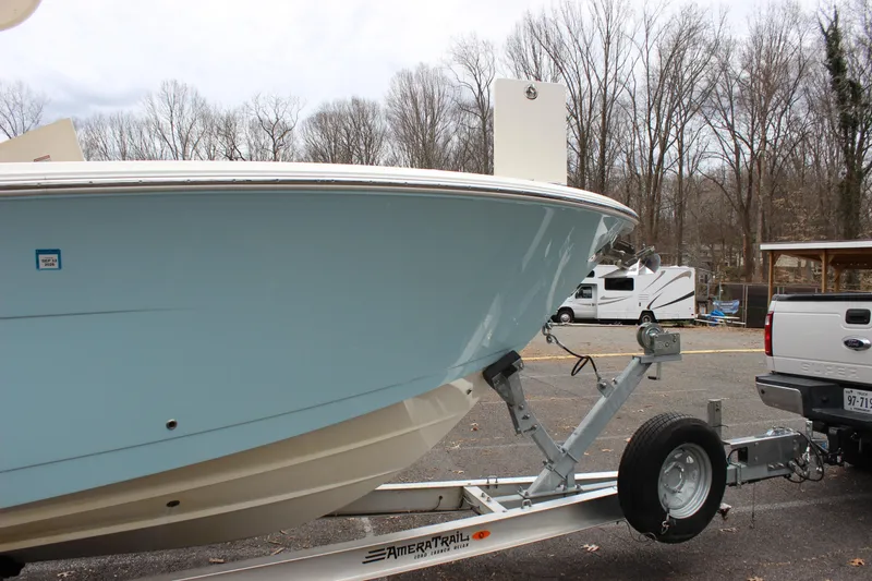 Slide: The Image of 2022 Cobia 280 Center Console boat on trailer in parking lot. - 5