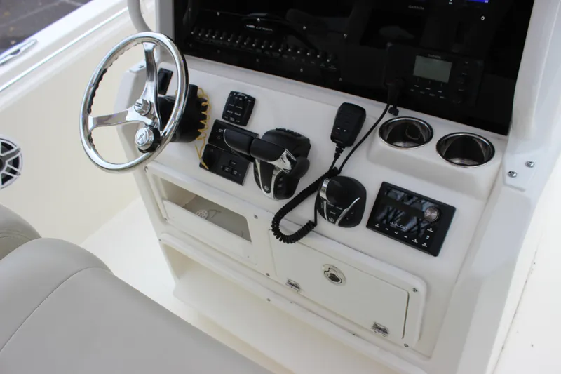 Slide: The Image of 2022 Cobia 280 Center Console dashboard with steering wheel and controls. - 51