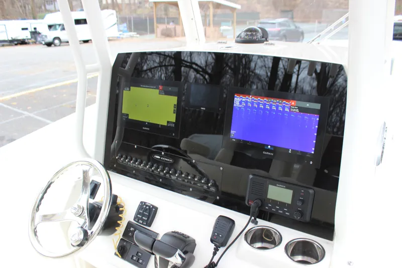 Slide: The Image of 2022 Cobia 280 Center Console dashboard with Garmin displays and steering wheel. - 52