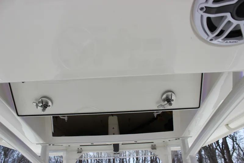 Slide: The Image of 2022 Cobia 280 Center Console boat with open storage compartment and speaker. - 53