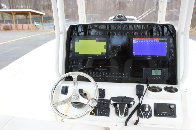 Slide: The Image of 2022 Cobia 280 Center Console dashboard with navigation screens and controls. - 55