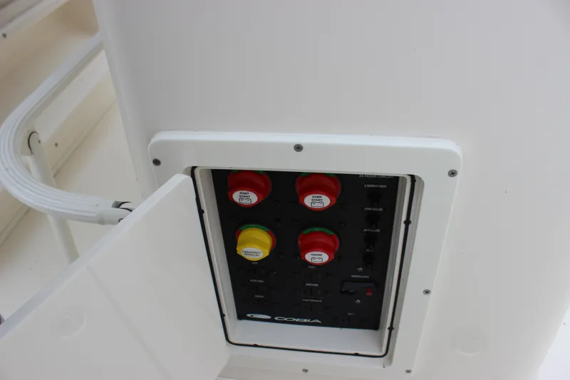 Slide: The Image of 2022 Cobia 280 Center Console electrical panel with labeled switches and controls. - 59