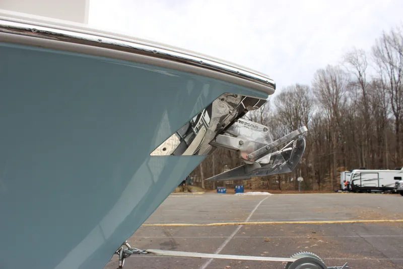 Slide: The Image of 2022 Cobia 280 Center Console boat with stainless steel anchor, parked outdoors. - 6