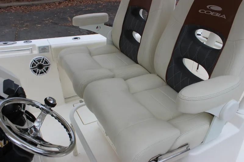 Slide: The Image of 2022 Cobia 280 Center Console boat interior with dual seats and steering wheel. - 63