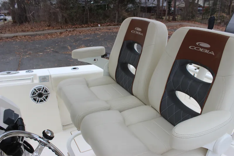 Slide: The Image of 2022 Cobia 280 Center Console boat seats with armrests and speaker detail. - 64