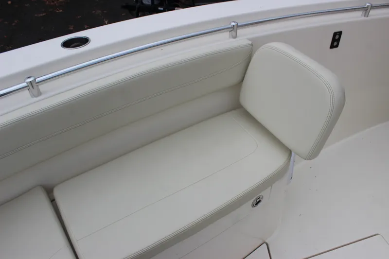 Slide: The Image of 2022 Cobia 280 Center Console boat with white cushioned seating. - 70