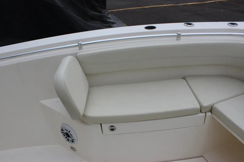 Slide: The Image of 2022 Cobia 280 Center Console boat seating area with white cushions. - 71