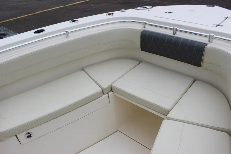 Slide: The Image of 2022 Cobia 280 Center Console boat with cushioned seating area. - 72