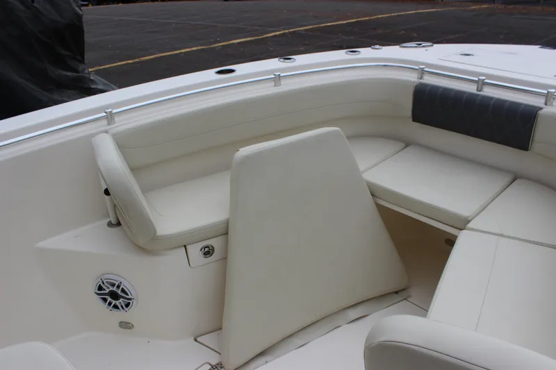 Slide: The Image of 2022 Cobia 280 Center Console boat interior with cushioned seating and speaker. - 73