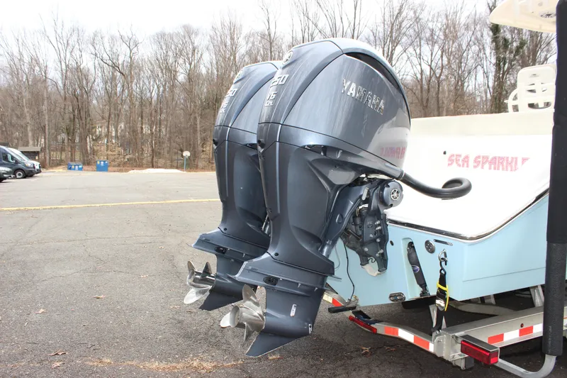 Slide: The Image of 2022 Cobia 280 Center Console with dual Yamaha outboard engines on a trailer. - 9