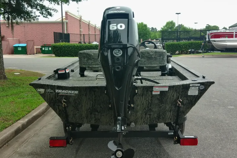 Slide: The Image of 2026 Tracker Grizzly 1754 SC boat with Mercury 60 engine, parked outdoors. - 3