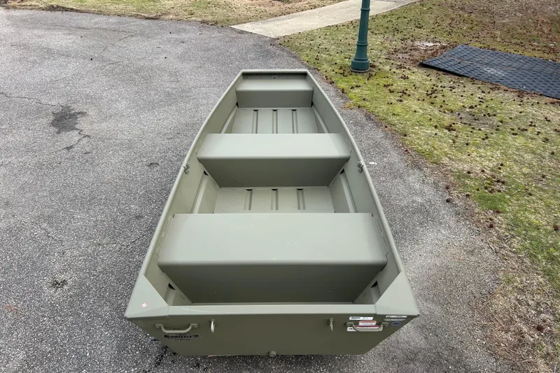 Slide: The Image of 2026 Tracker Grizzly 12 Jon boat on pavement, showcasing its sturdy design. - 3
