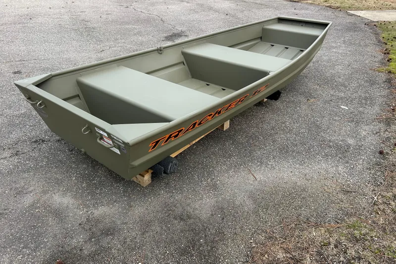 Slide: The Image of 2026 Tracker Grizzly 12 Jon boat on pavement, showcasing its sturdy design. - 4