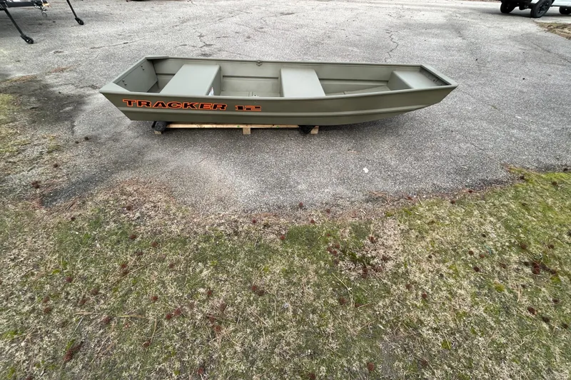 Slide: The Image of 2026 Tracker Grizzly 12 Jon boat on pavement, showcasing its sturdy design. - 5