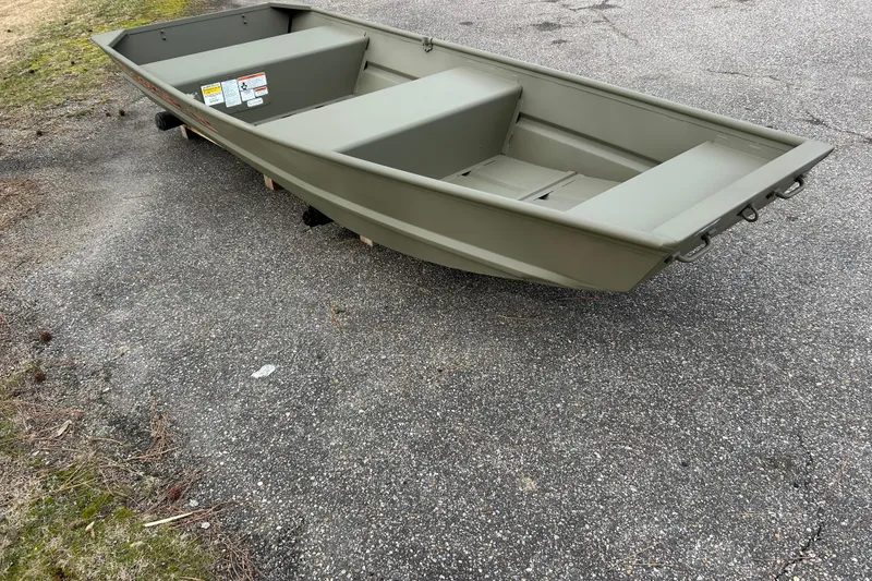 Slide: The Image of 2026 Tracker Grizzly 12 Jon boat on pavement, showcasing its sturdy design. - 6