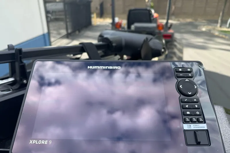 Slide: The Image of Humminbird Xplore 9 display on Ranger ALPHA 208, 2026 model, reflecting cloudy sky. - 78