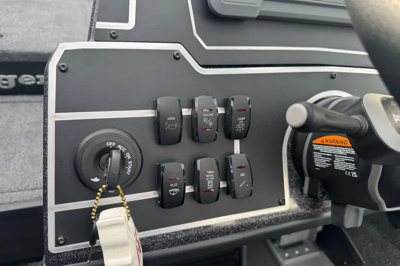 Slide: The Image of Control panel of 2026 Ranger ALPHA 208 boat with switches and ignition key. - 87