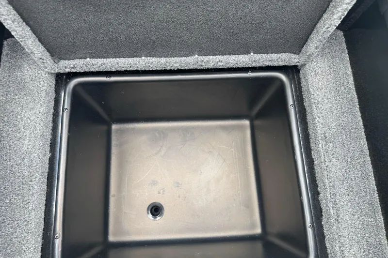 Slide: The Image of Interior storage compartment of 2026 Ranger ALPHA 208, featuring a black plastic bin. - 92