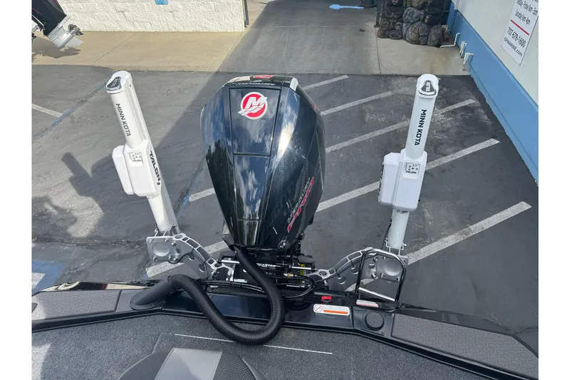 Slide: The Image of 2026 Ranger ALPHA 208 boat engine with Minn Kota Talon anchors in a parking lot. - 97