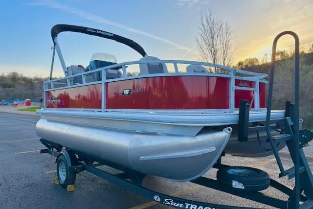 Slide: The Image of 2026 Sun Tracker Bass Buggy 16 XL Select pontoon boat on trailer at sunset. - 113
