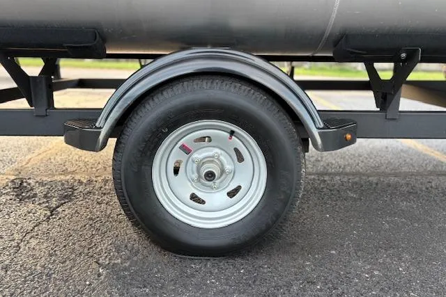 Slide: The Image of Trailer wheel of 2026 Sun Tracker Bass Buggy 16 XL Select on asphalt. - 96