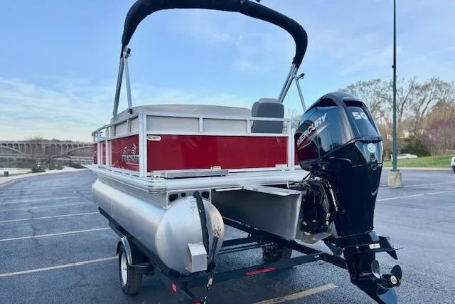 Slide: The Image of 2026 Sun Tracker Bass Buggy 16 XL Select pontoon boat with Mercury 50 engine in parking lot. - 99