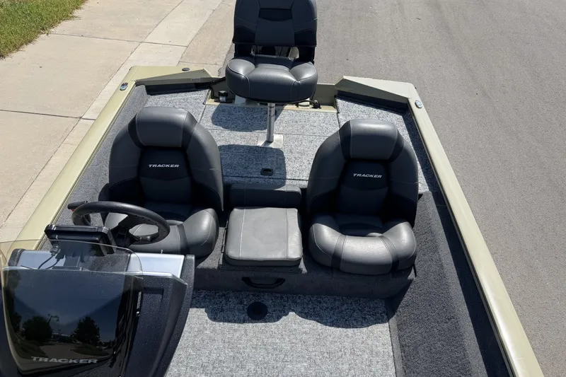 Slide: The Image of 2026 Tracker Pro Team 175 boat interior with black seats and steering console. - 16