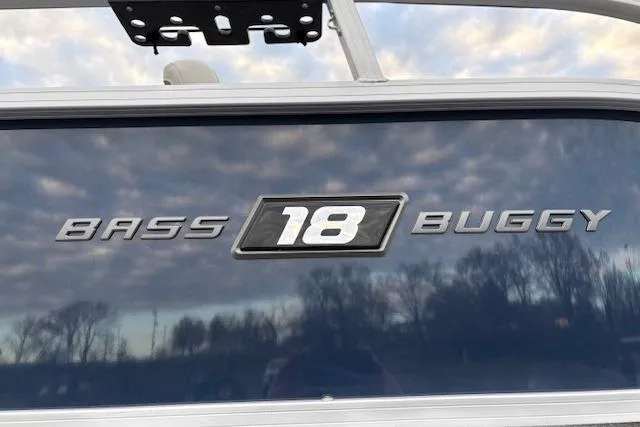 Slide: The Image of 2026 Sun Tracker Bass Buggy 18 DLX boat logo against a cloudy sky backdrop. - 102