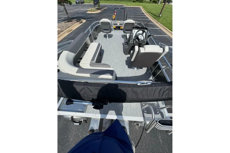 Slide: The Image of 2026 Sun Tracker Bass Buggy 16 XL Select pontoon boat interior with seating and steering console. - 4
