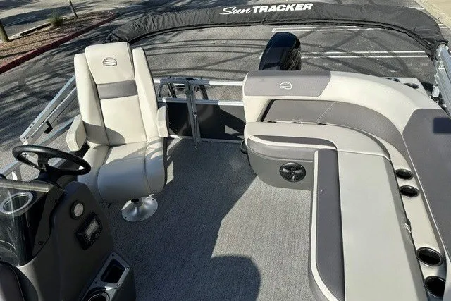 Slide: The Image of 2026 Sun Tracker Bass Buggy 16 XL Select pontoon boat interior with seating and helm. - 13