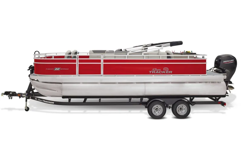 Slide: The Image of 2026 Sun Tracker Fishin' Barge 22 DLX pontoon boat interior with seating and steering console. - 8
