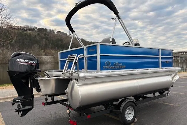 Slide: The Image of 2026 Sun Tracker Party Barge 16 DLX pontoon boat with Mercury engine on trailer. - 81