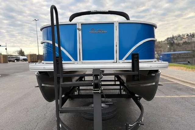 Slide: The Image of 2026 Sun Tracker Party Barge 16 DLX pontoon boat on trailer, blue exterior. - 82