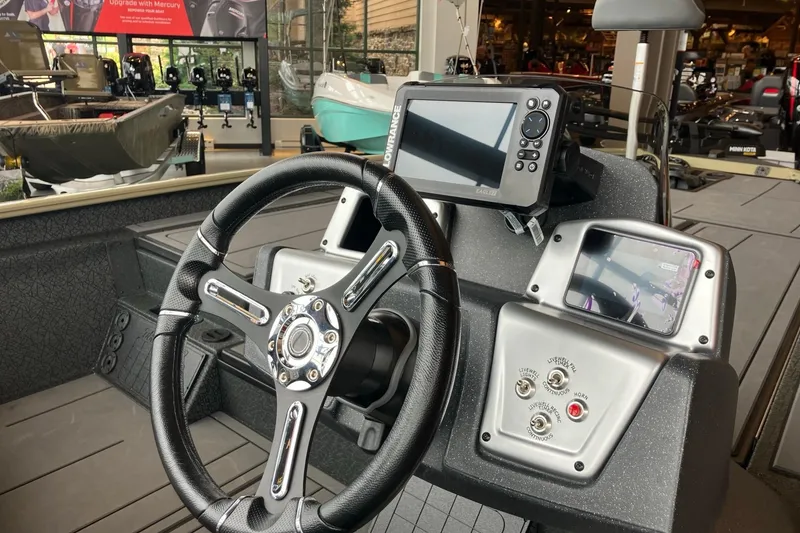 Slide: The Image of Steering console of 2026 Tracker Savage 215 boat with navigation equipment. - 4