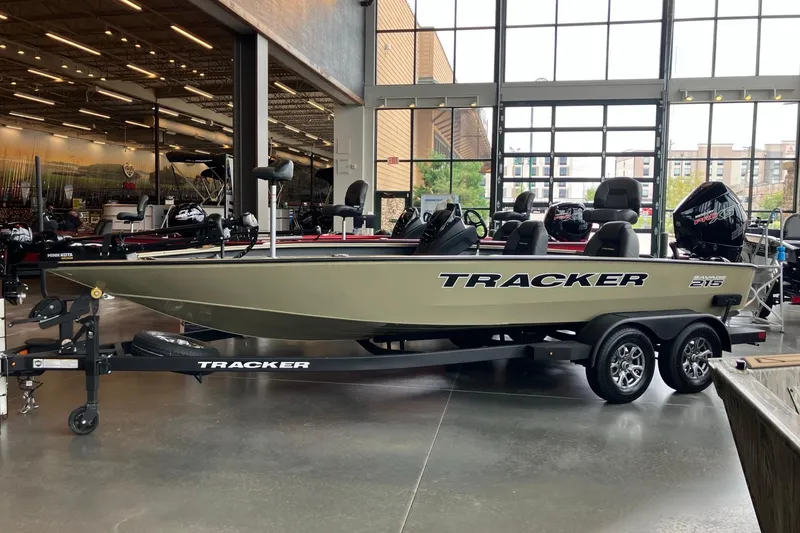 The Image of 2026 Tracker Savage 215 boat displayed in a showroom, on a trailer. - 0