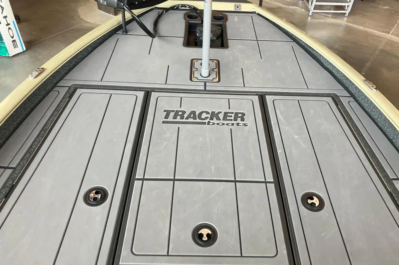 Slide: The Image of Deck of 2026 Tracker Savage 215 boat with logo and storage compartments. - 12