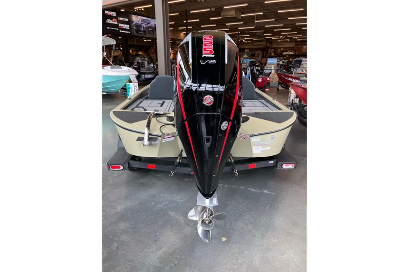 Slide: The Image of 2026 Tracker Savage 215 boat with powerful V8 engine displayed indoors. - 3