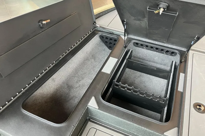 Slide: The Image of Open storage compartments in a 2026 Tracker Savage 215 boat. - 13
