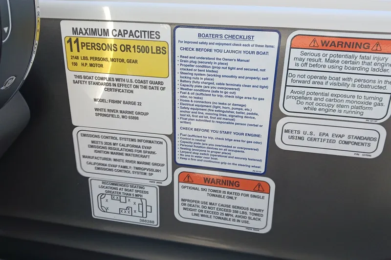 Slide: The Image of 2026 Sun Tracker Fishin' Barge 22 DLX capacity and safety labels on dashboard. - 12