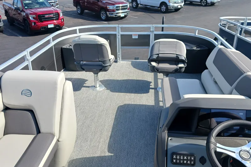 Slide: The Image of 2026 Sun Tracker Fishin' Barge 22 DLX interior with seating and steering wheel. - 14
