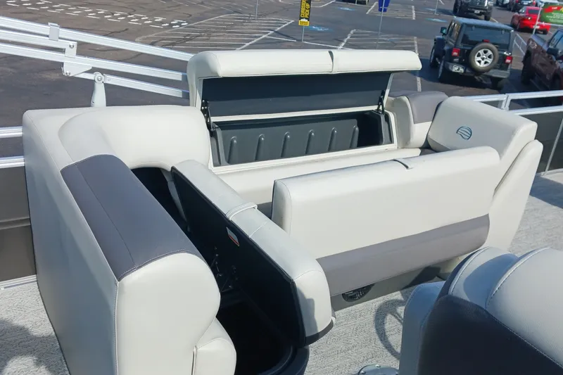 Slide: The Image of 2026 Sun Tracker Fishin' Barge 22 DLX interior with open storage compartments. - 13