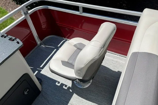 Slide: The Image of 2026 Sun Tracker Fishin' Barge 22 DLX boat seat with red and gray interior. - 110