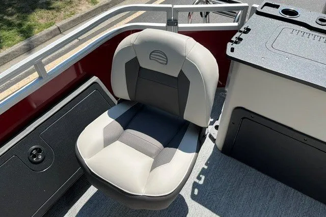 Slide: The Image of 2026 Sun Tracker Fishin' Barge 22 DLX boat seat, gray and black, with console nearby. - 111
