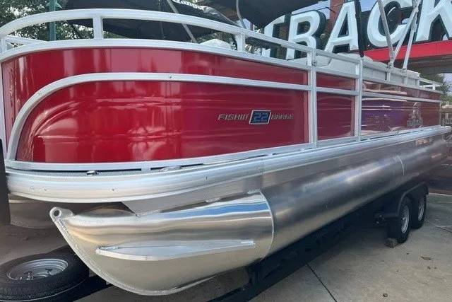 Slide: The Image of 2026 Sun Tracker Fishin' Barge 22 DLX pontoon boat with red and silver design. - 17