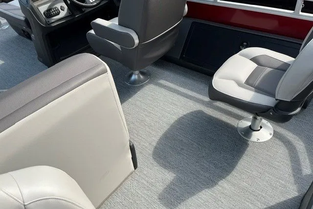 Slide: The Image of Interior of 2026 Sun Tracker Fishin' Barge 22 DLX with comfortable seating and steering console. - 12