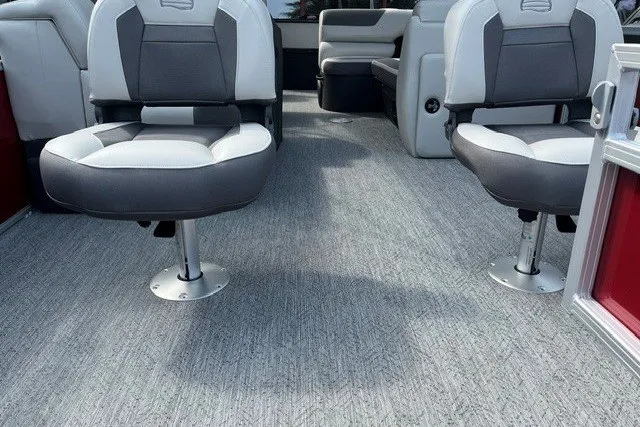 Slide: The Image of 2026 Sun Tracker Fishin' Barge 22 DLX interior with comfortable seating and carpeted flooring. - 14